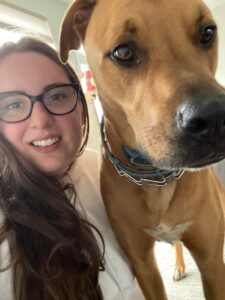 A woman and her dog are smiling for the camera.