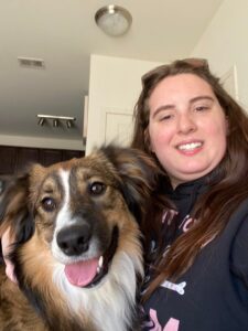 A woman and her dog are smiling for the camera.