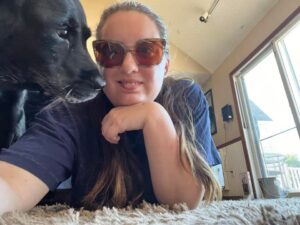 A woman and her dog laying on the floor